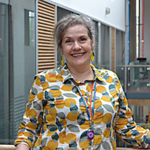 A photograph of librarian, Marie, smiling at the camera