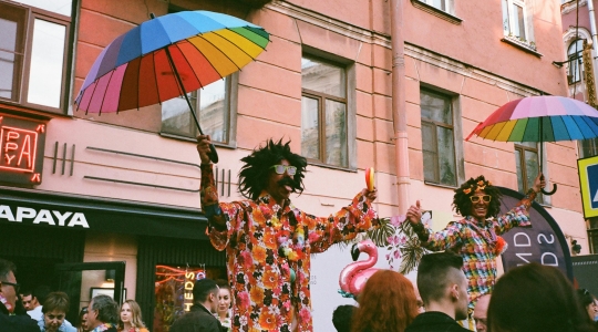 https://www.pexels.com/photo/two-men-performs-on-stage-while-holding-rainbow-colored-umbrellas-2422474/