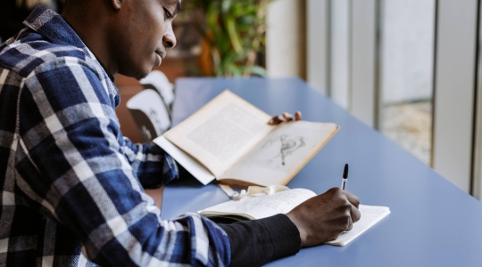 Black man studying alone in the Library