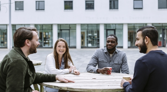 Students gathered around a picnic table