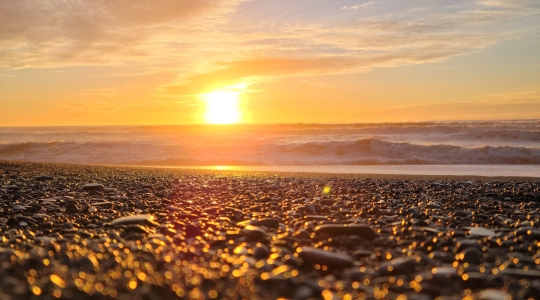 Sunset over a rocky seashore - from Pexels, https://www.pexels.com/photo/setting-sun-over-sea-horizon-23652305/