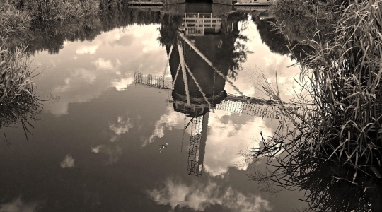 Reflection in water of a Dutch windmill.  From Pixabay - https://pixabay.com/photos/windmill-dutch-holland-historic-1537634/