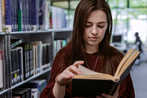 Woman reading a book in the Library