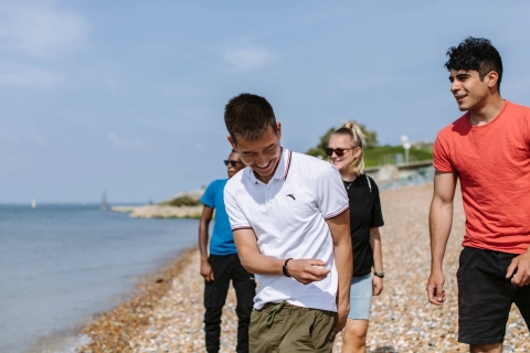 Students walking along Southsea beach