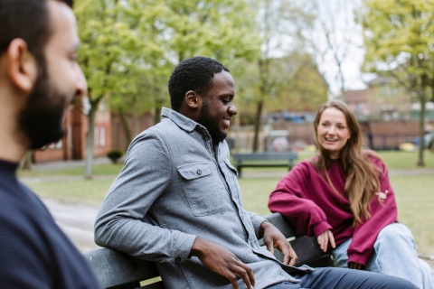Students sat chatting on a bench in Ravelin Park