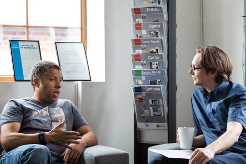 Two men talking indoors