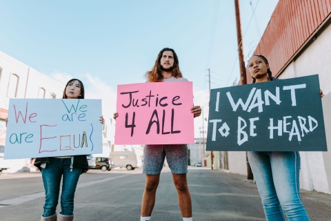 An Asian woman, a White man, and a Black woman standing side by side carrying placards that read: We are all equal, Justice 4 all, and I want to be heard, respectively.  From Pexels - https://www.pexels.com/photo/text-6257070/