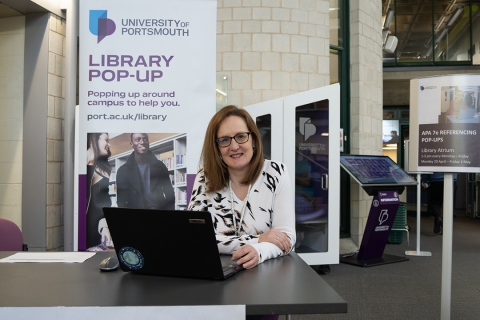 Librarian staffing a referencing pop-up in the Library Atrium