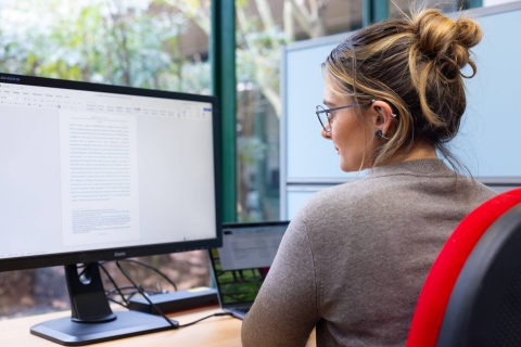 Woman working at a computer in the Library