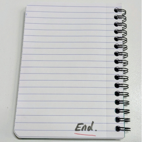 Notebook with the word "End" written at the bottom right of the last page - an 'end note".