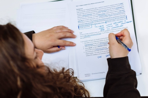 Woman proofreading and annotating a document