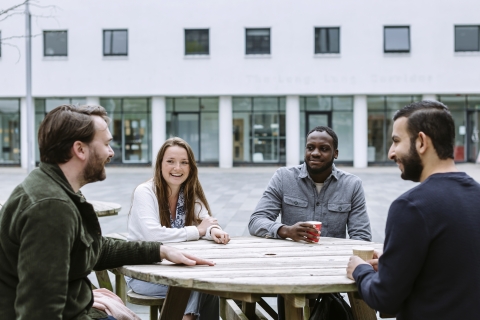 Students gathered around a picnic table