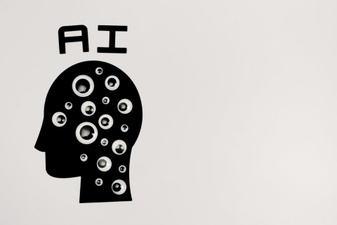 Illustration of "AI" with a human head covered in eyes