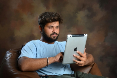 PGM man reading from an iPad, from Pexels - https://www.pexels.com/photo/sitting-man-with-ipad-19613567/