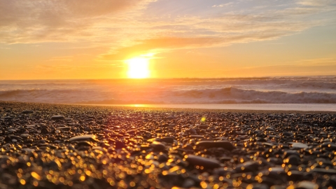 Sunset over a rocky seashore - from Pexels, https://www.pexels.com/photo/setting-sun-over-sea-horizon-23652305/
