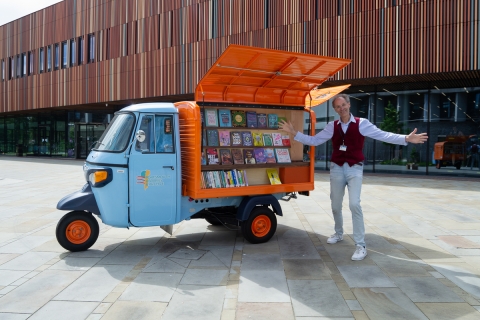 Librarian from the public library presenting the tuk-tuk full of books