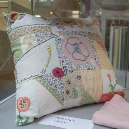 Cushion made using embroidery and sewn together textile patches