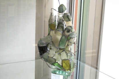 Human hand crafted from broken glass fragments soldered together