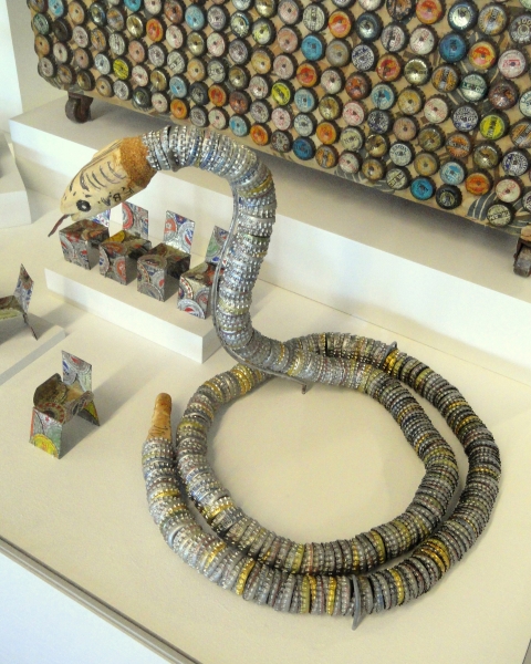 "Bottle cap snake" Folk art item exhibited in the San Francisco airport, San Franciso, California, USA. Item from the collection of the Museum of International Folk Art, Santa Fe, New Mexico, USA. - Public Domain image from Wikimedia Commons - https://commons.wikimedia.org/wiki/File:Bottle_cap_snake_-_Museum_of_International_Folk_Art_-_DSC09187.JPG