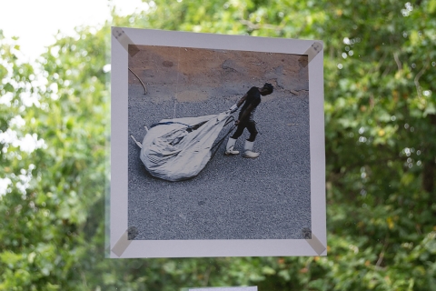 African man dragging sack of rubbish