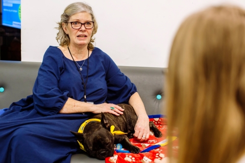 Lady in blue dress with support dog