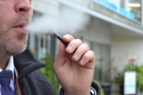A person vaping outside of the library