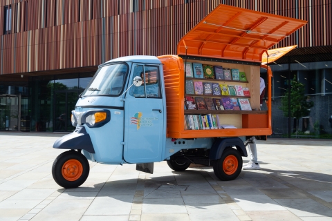 Public library tuk-tuk book van with side panel lifted to display books