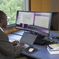Student on a laptop with a second screen
