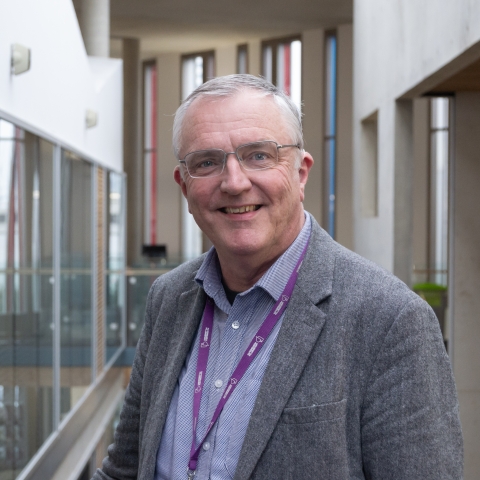 A photograph of librarian, Timothy Collinson, smiling at the camera